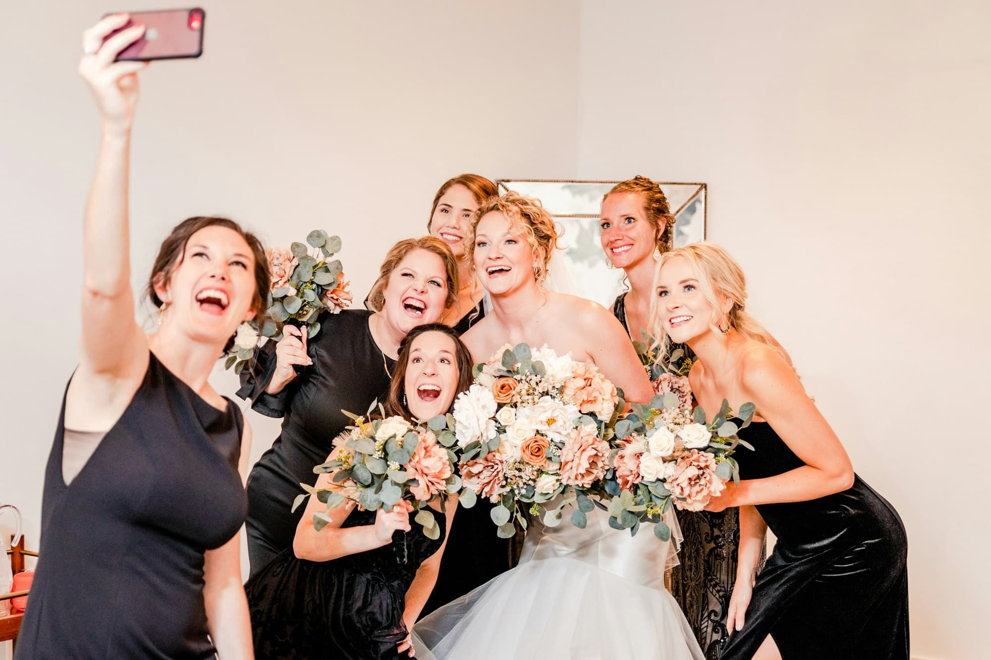 Bride and bridesmaids taking a selfie together